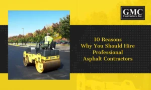 Asphalt contractors paving residential driveway with heavy roller equipment